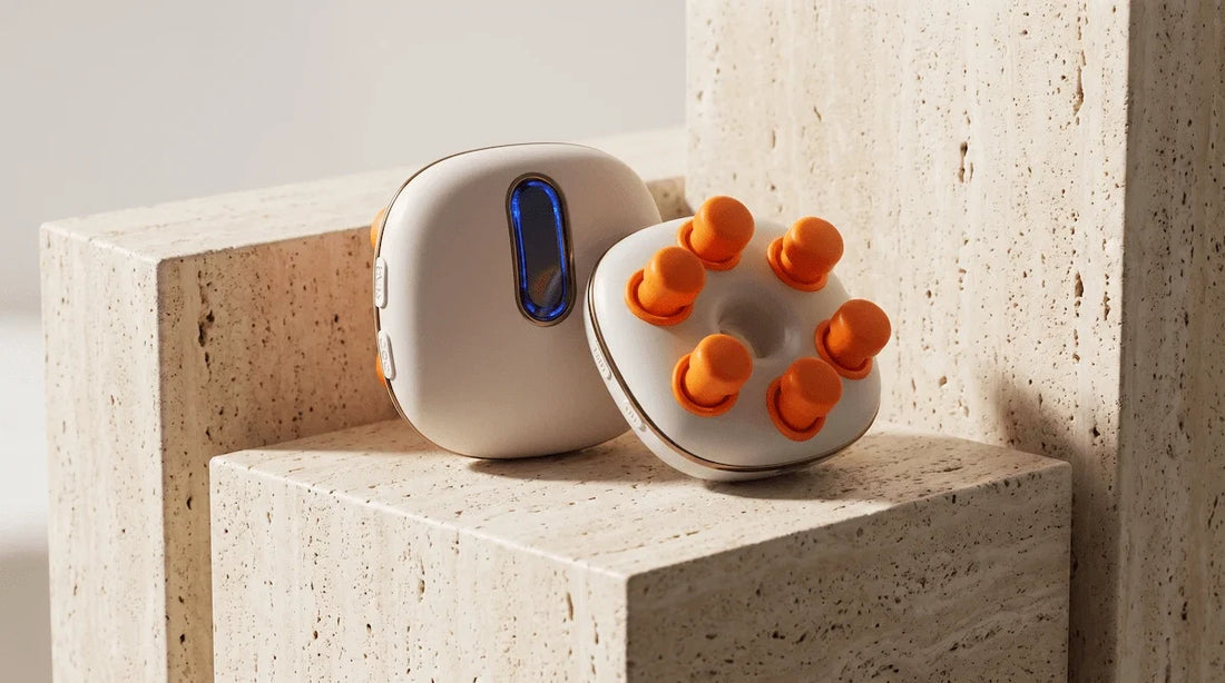 Premium display of a white handheld eye massager on a geometric stone pedestal.