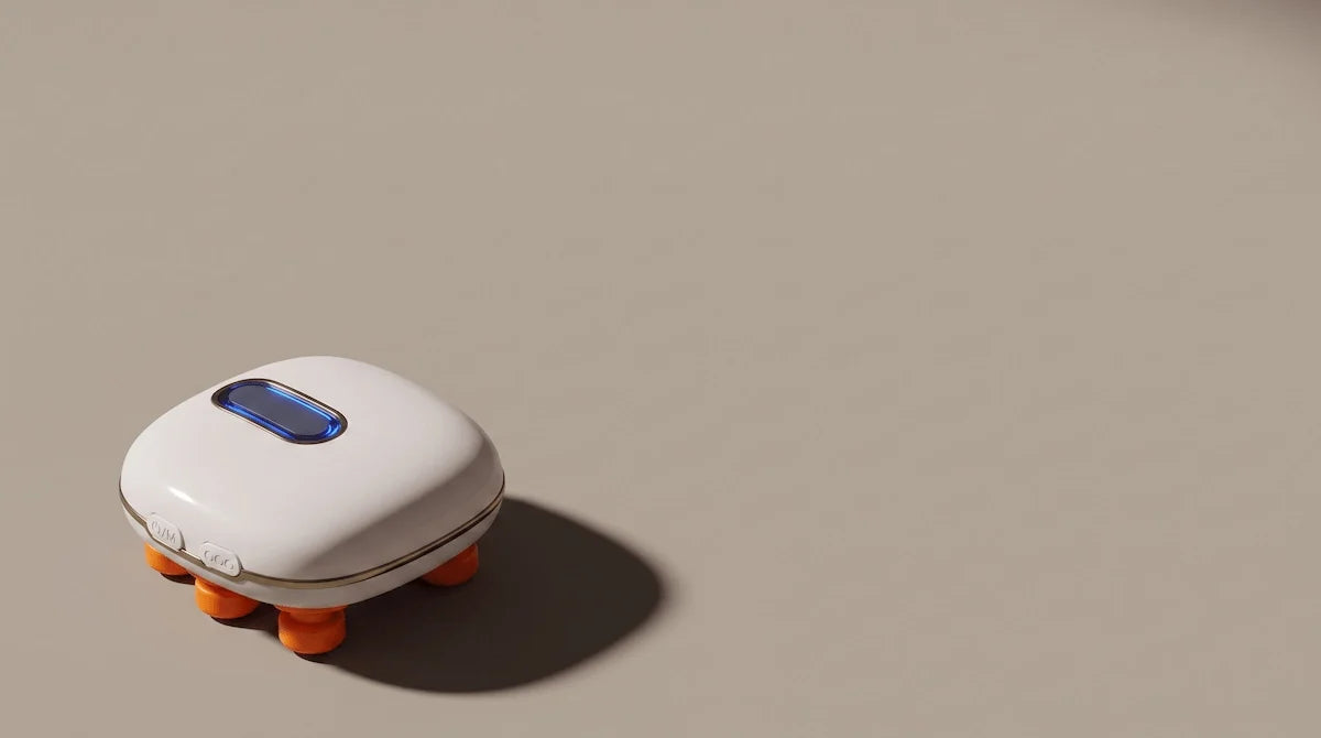 Minimalist flat lay of a white handheld eye massager on a warm grey background.