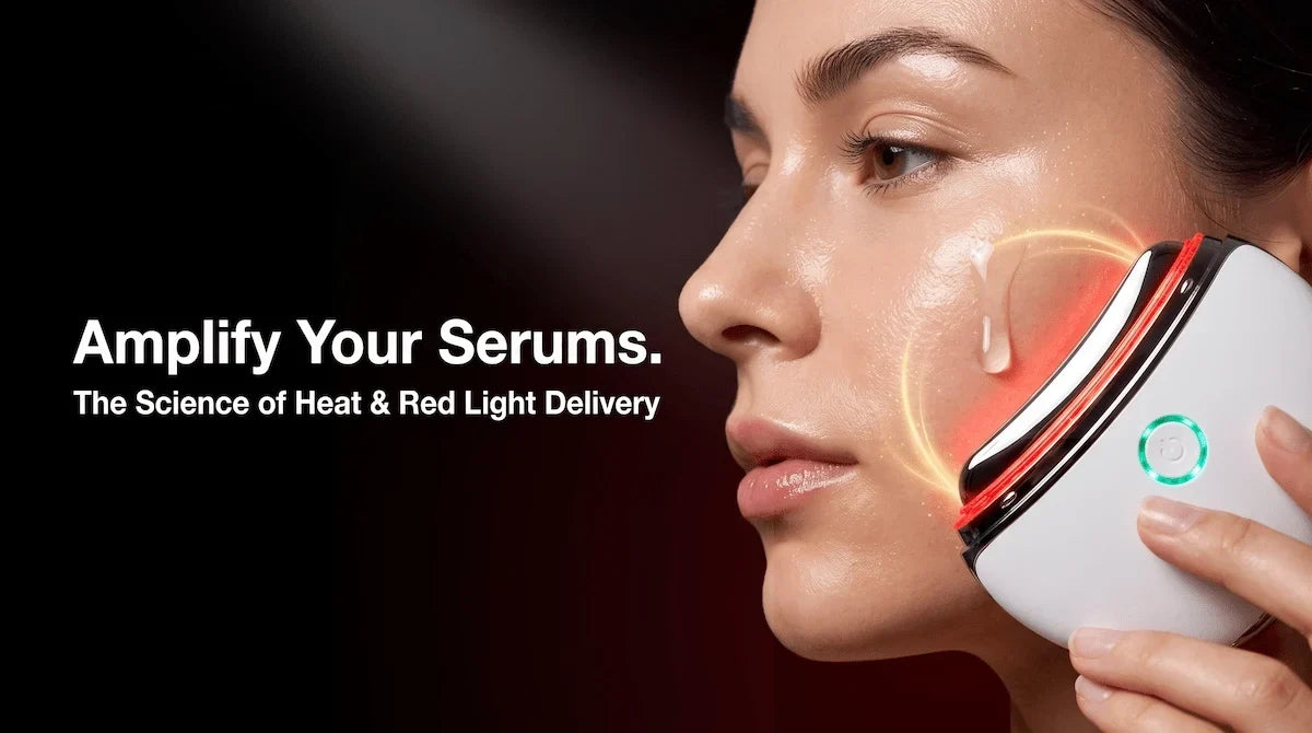 Close-up of a woman using the ELEVAURE red light and heat therapy device to boost the absorption of a facial serum.