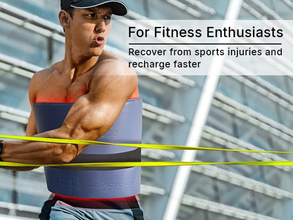 Athletic fitness enthusiast wearing the flexible red light therapy pad wrapped around his torso during post-workout muscle recovery routines.