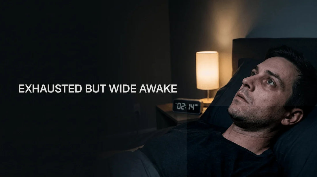 Exhausted man lying awake in bed at 2 AM suffering from sleep onset latency.