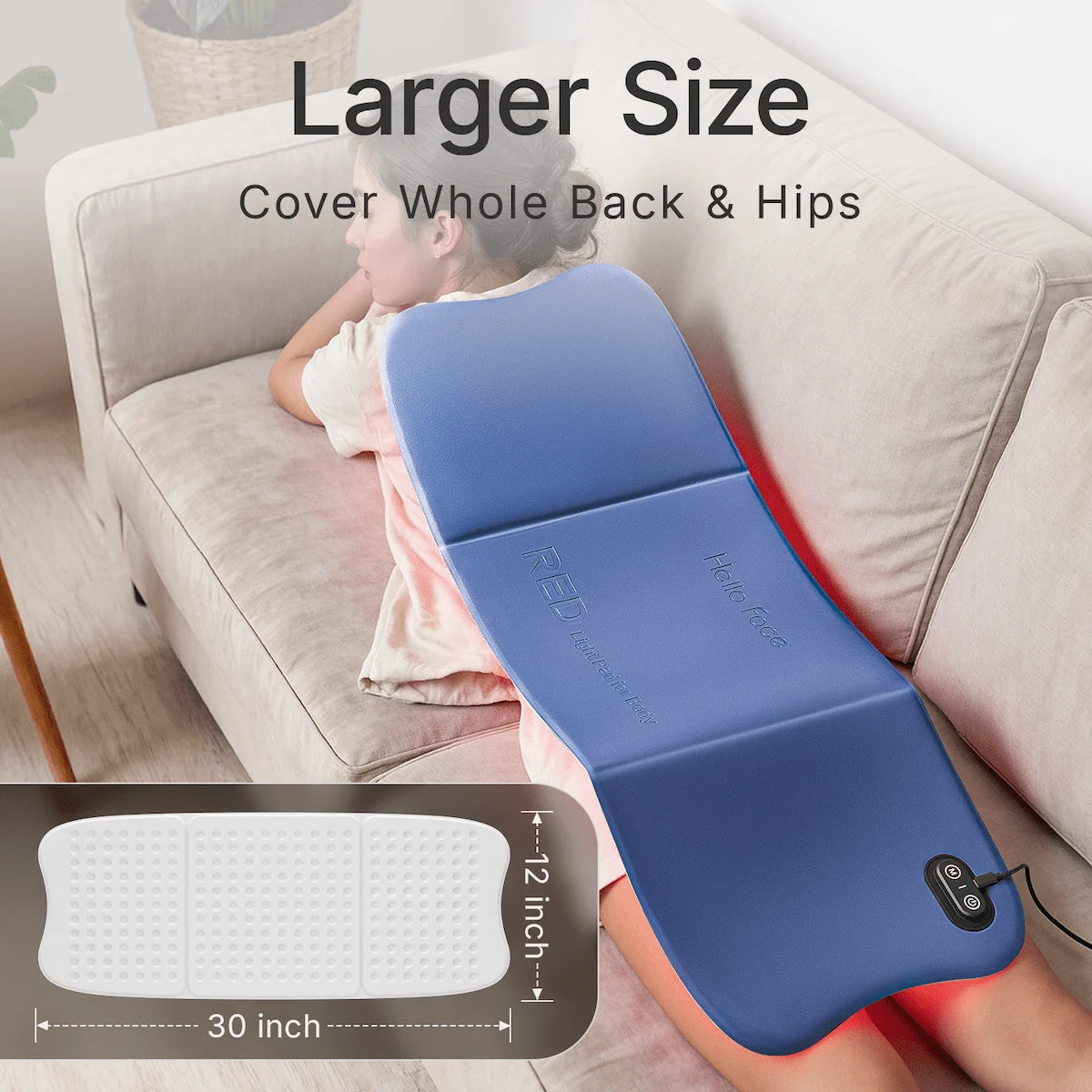 Woman resting prone on a sofa with the large 30.1" × 12.0" flexible red light pad covering her entire back and waist area.