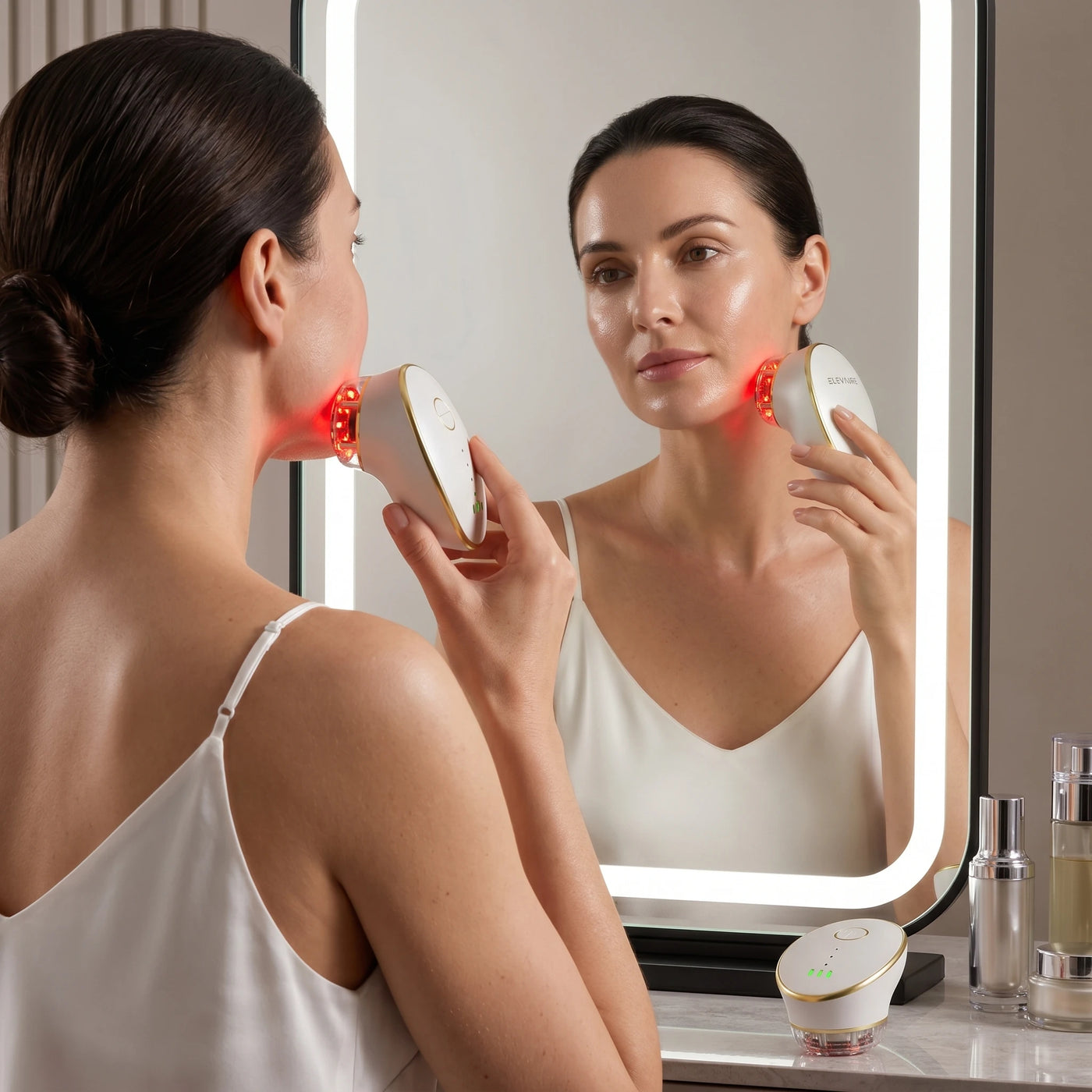 Woman performing a morning facial lymphatic drainage routine using the ELEVAURE electric suction face massager to depuff her face fast.