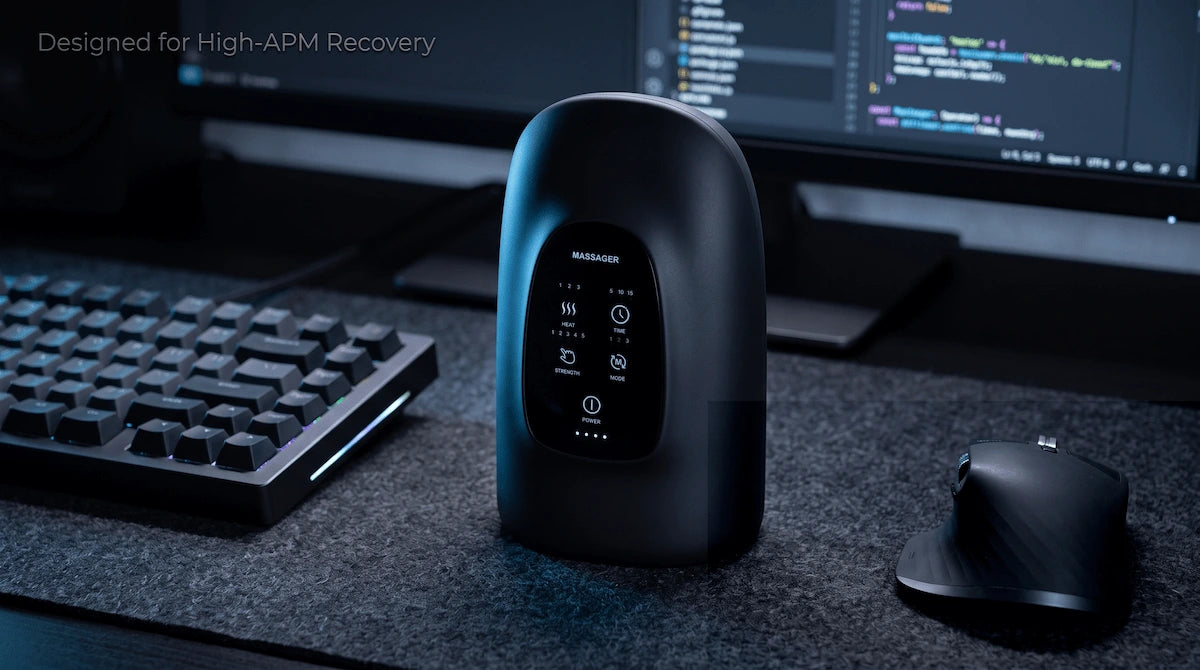 Midnight black hand massager next to mechanical keyboard for programmer hand fatigue recovery.
