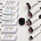 Flat lay presentation of all 6-in-1 system attachments, including 8 LLLT pads, RF probes, cavitation head, and vacuum handle.