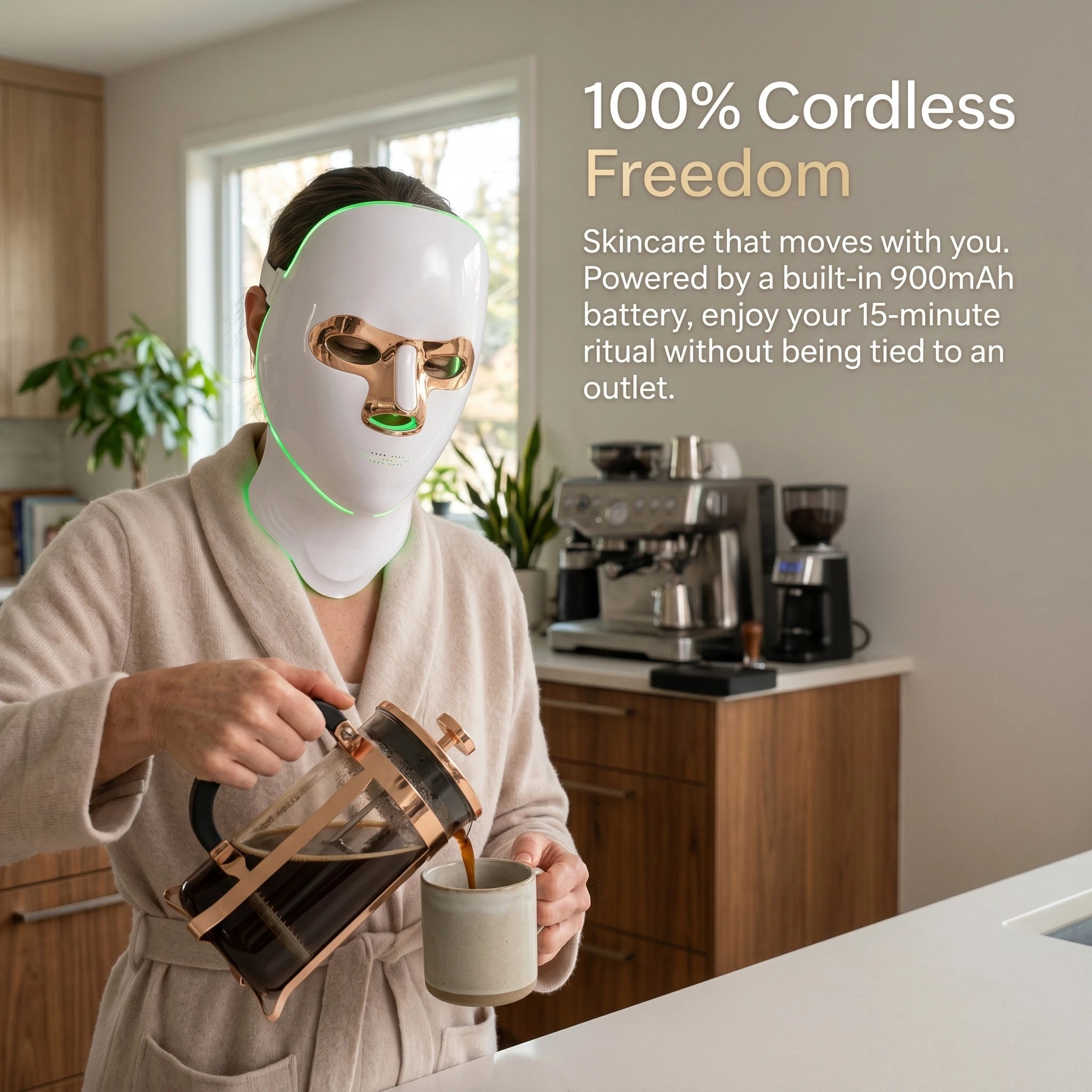 Woman pouring coffee in a modern kitchen while wearing a cordless, battery-powered LED facial mask, demonstrating a 100% hands-free morning skincare routine.