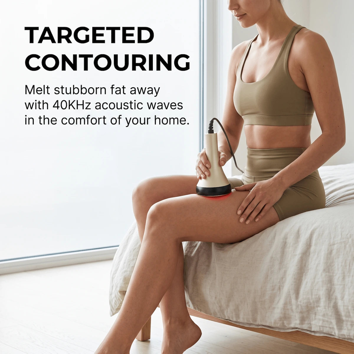 Woman applying the Elevaure 40KHz cavitation handpiece to her thigh, targeting stubborn fat deposits with acoustic wave technology at home.
