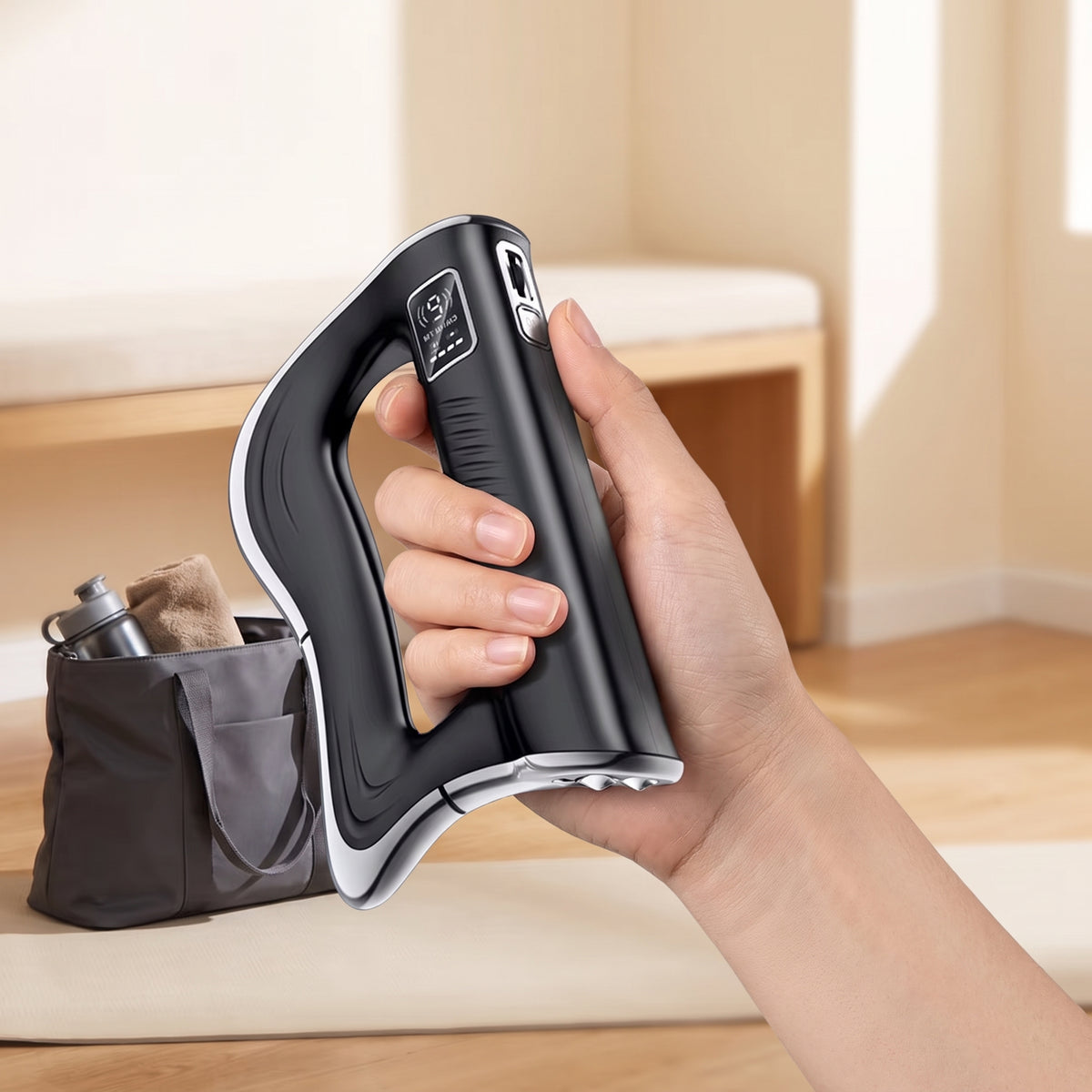 Hand holding the Elevaure fascia scraper away from the skin, rolling the side intensity dial while the LED screen displays mode and battery level.