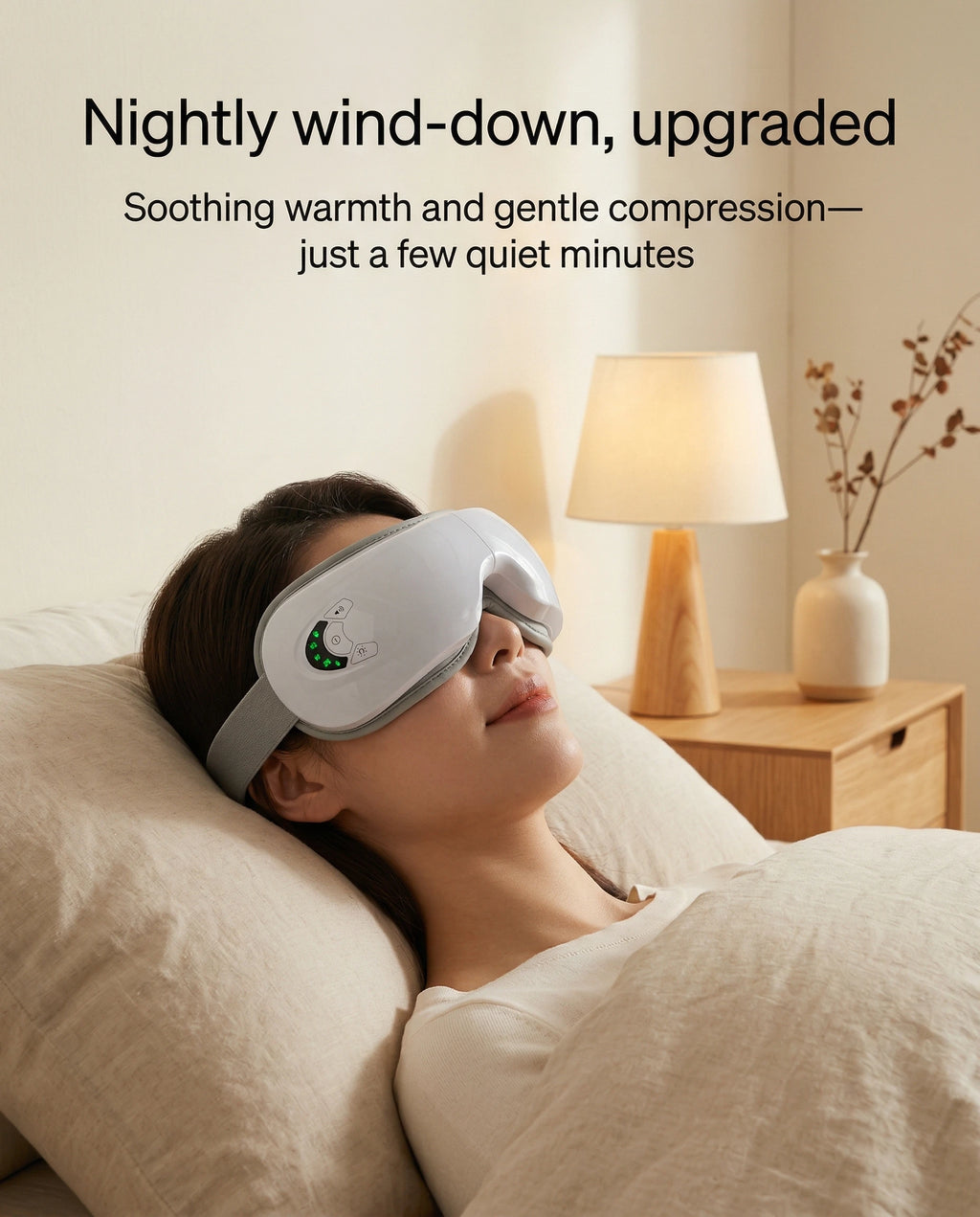 Woman using elevaure heated eye massager at night in bedroom