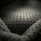 Macro shot of the soft, breathable acupressure fabric inside the Elevaure hand relaxation device.