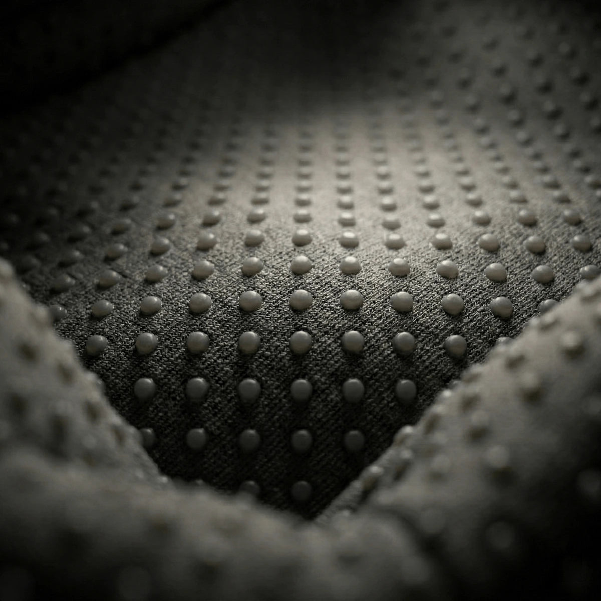 Macro shot of the soft, breathable acupressure fabric inside the Elevaure hand relaxation device.