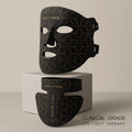 The Elevaure clinical-grade LED light therapy mask and neck attachment resting on a minimalist marble surface.