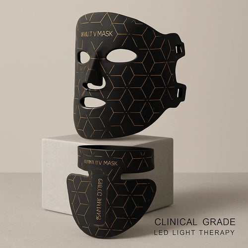 The Elevaure clinical-grade LED light therapy mask and neck attachment resting on a minimalist marble surface.