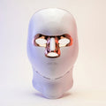 White minimalist LED light therapy mask for face and neck by Elevaure, featuring rose gold accents, intuitive touch sensor, and functional ventilation grid.