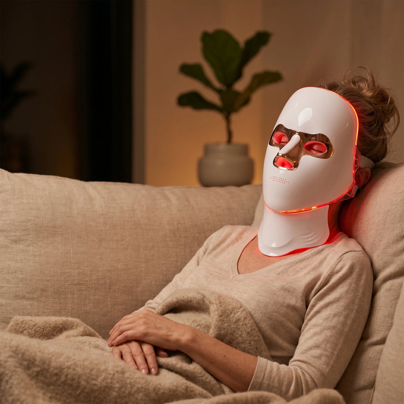 Woman relaxing while wearing the Elevaure LED face and neck mask.