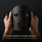 Close-up of a hand gently bending the Elevaure LED mask, demonstrating its soft, flexible medical-grade silicone material.