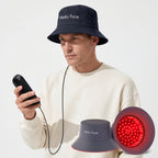 Mature man using ELEVAURE red light hair growth cap with smart wired controller for targeted scalp phototherapy.