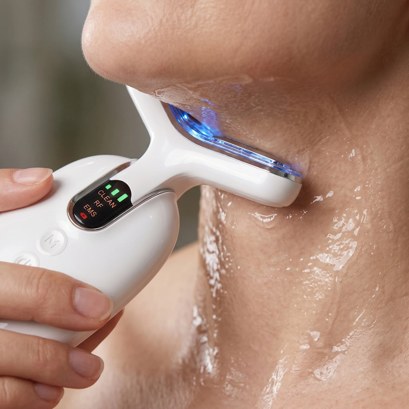 Close up of the ELEVAURE RF device gliding along a woman's neck and jawline, demonstrating the easy at-home routine for tech neck treatment.
