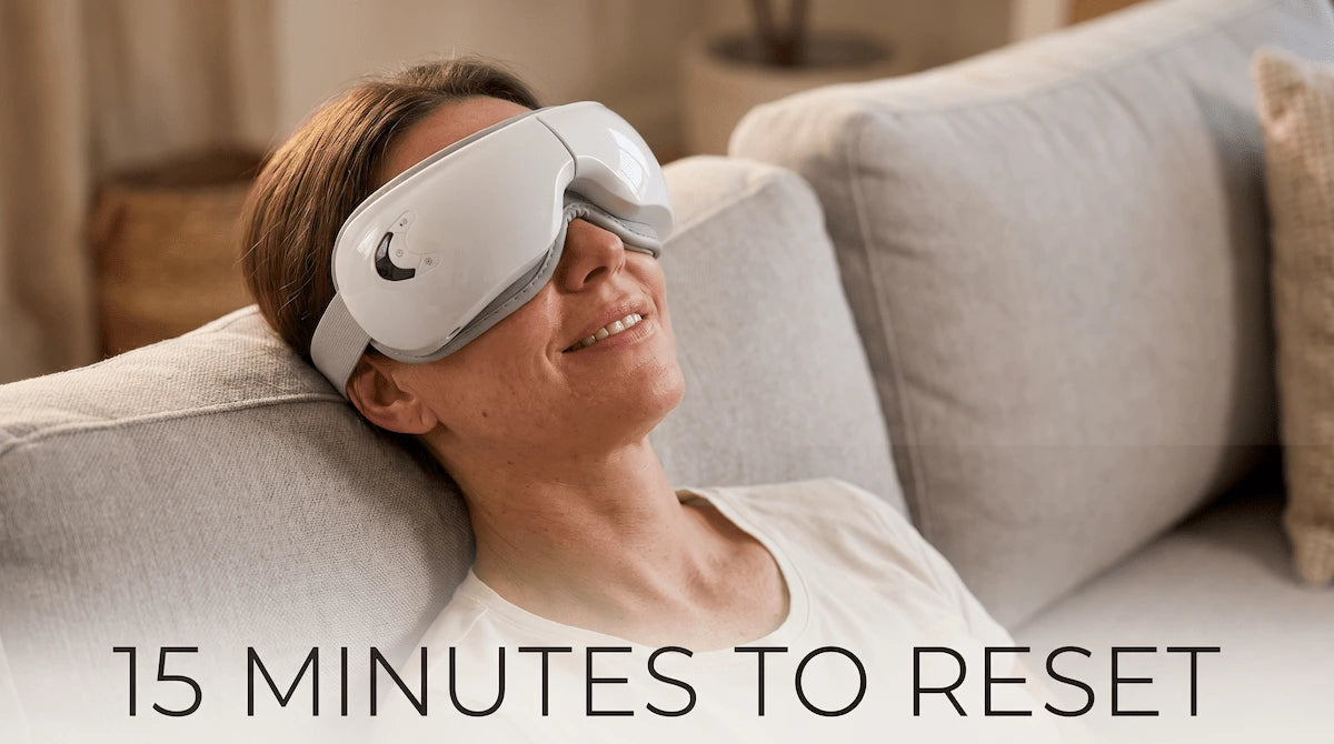 Woman relaxing on a couch wearing the Elevaure smart eye massager.