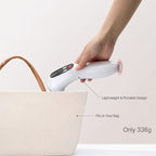 A hand slips the ELEVAURE ultrasound massager into a tote bag to show its lightweight, portable size.