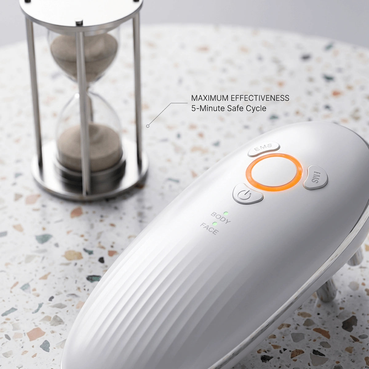 Elevaure body sculpting massager placed next to a sand timer, illustrating the 5-minute maximum safe cycle per body area recommended for EMS and LIPO suction sessions.