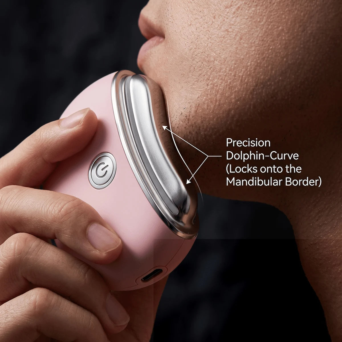 Close-up showing the dolphin-curve head of the Elevaure electric gua sha perfectly hugging the mandibular border for maximum lifting.