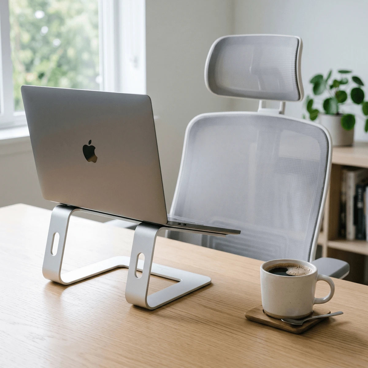 Ergonomic home office desk setup with monitor riser and wellness accessories — prevention starts at the desk.