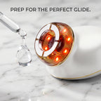 A crystal clear water-based serum droplet next to the electric facial gua sha tool, essential for prepping the skin before using the face lifting machine.
