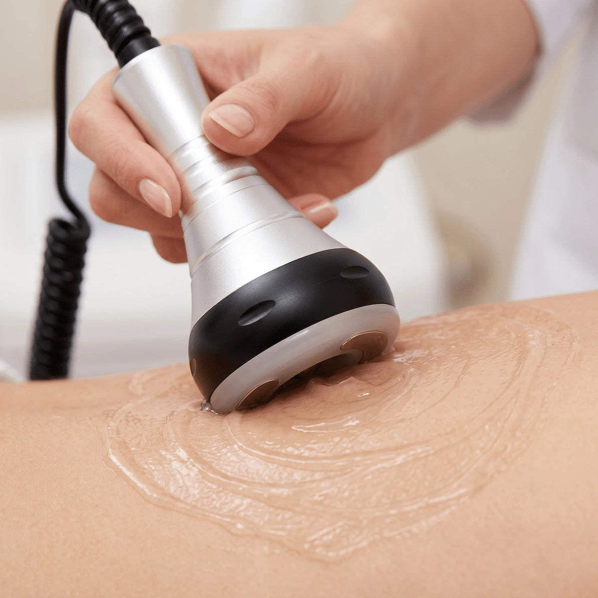 Moving the body contouring probe in slow, circular upward strokes across the treatment area.