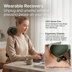 Woman working on a laptop while wearing the hands-free ELEVAURE neck massager, featuring a close-up of the U-shaped ergonomic curve.