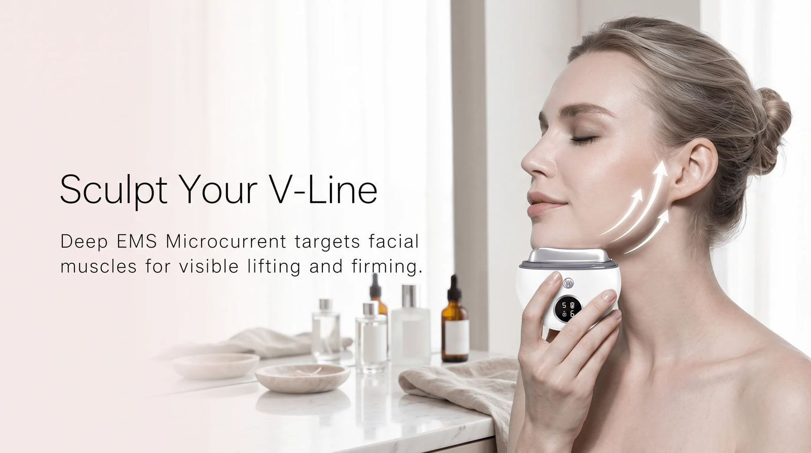 Woman using the 4-in-1 EMS face massager to sculpt and lift her jawline.