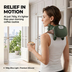 Woman enjoying her morning coffee while wearing the 760g ultra-lightweight ELEVAURE neck massager.