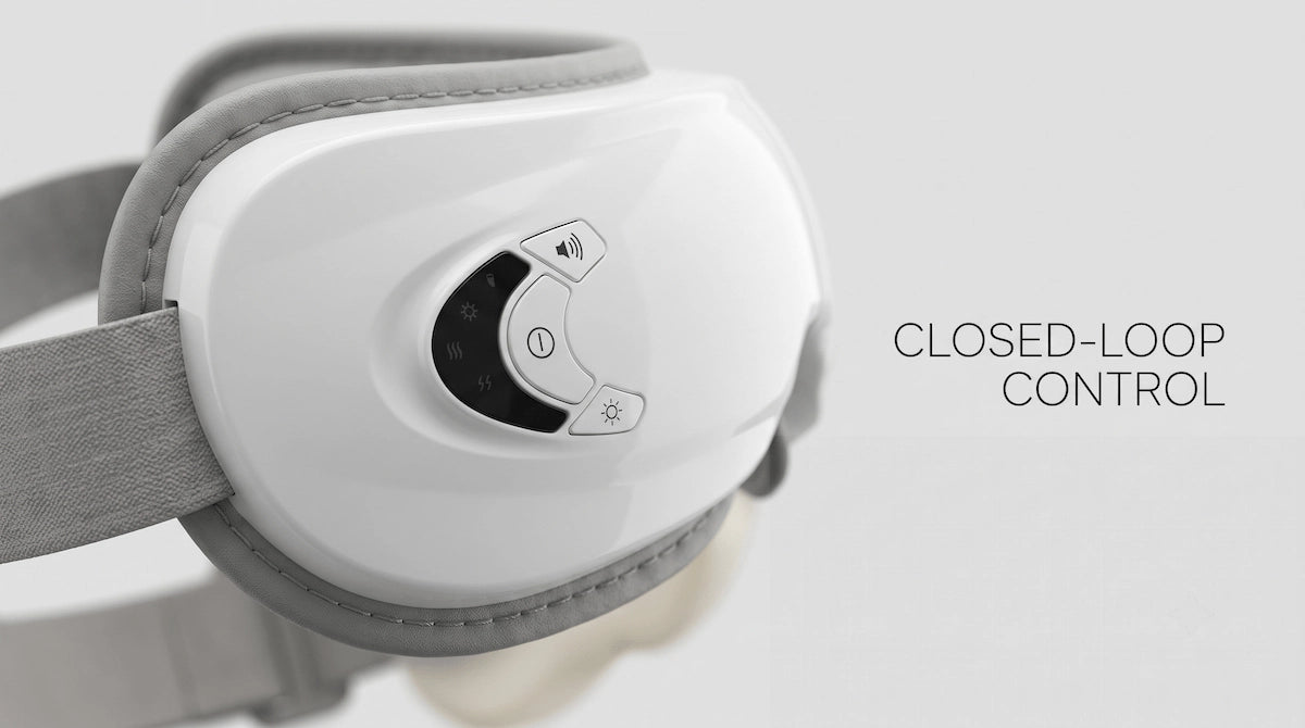 Macro close-up of the Elevaure eye massager control panel highlighting its precision engineering.