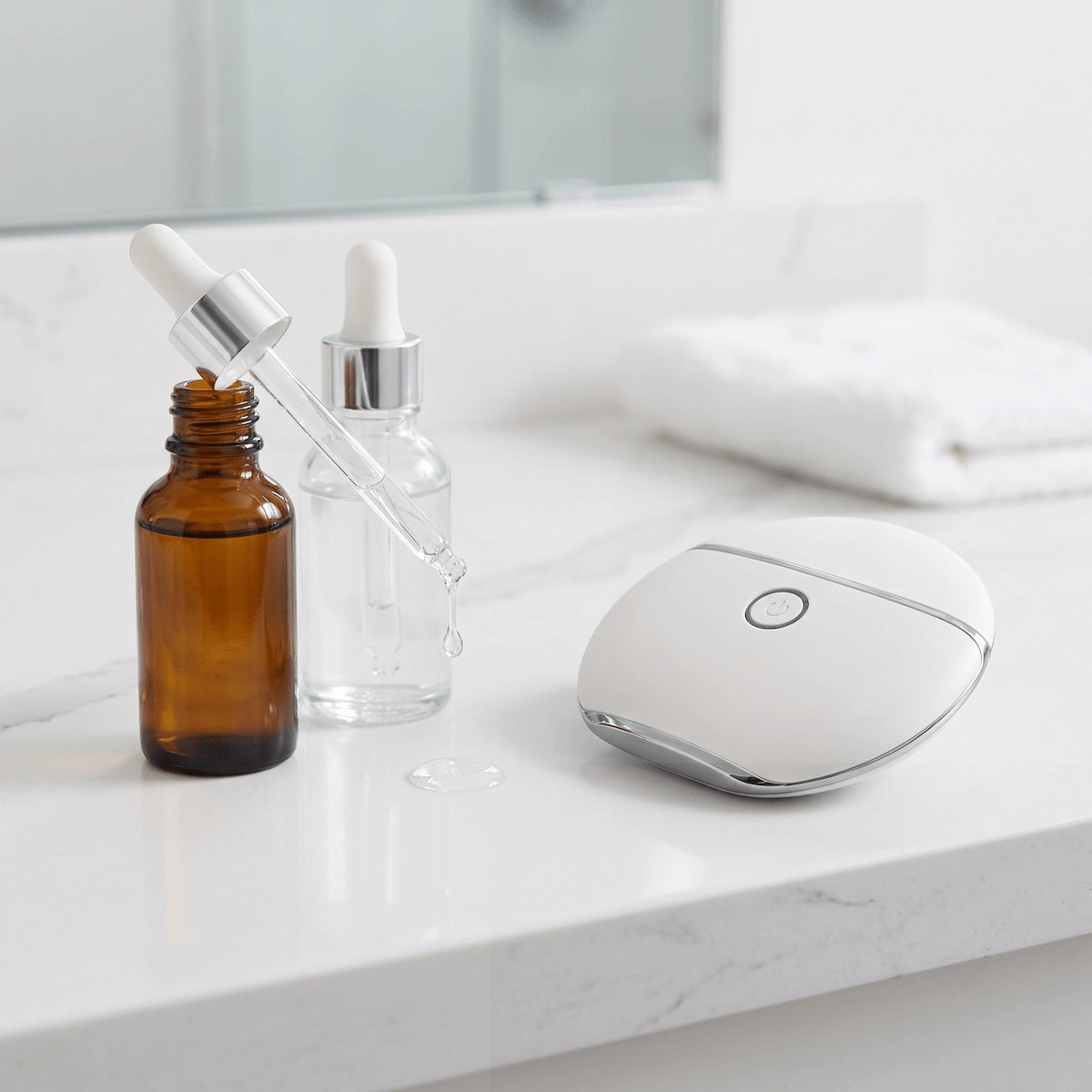 Morning skincare routine with REVITALIZE™ heated gua sha massager — applying facial oil before vibration mode for lymphatic drainage and serum absorption.