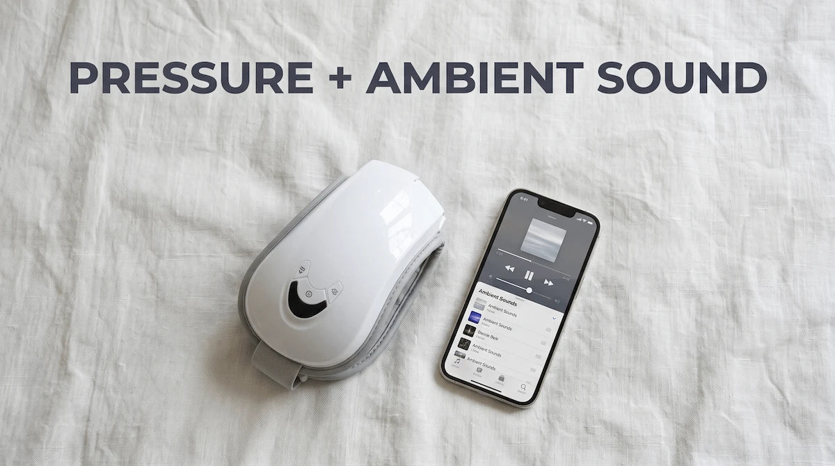Folded Elevaure smart eye massager next to a smartphone on premium linen bedsheets.