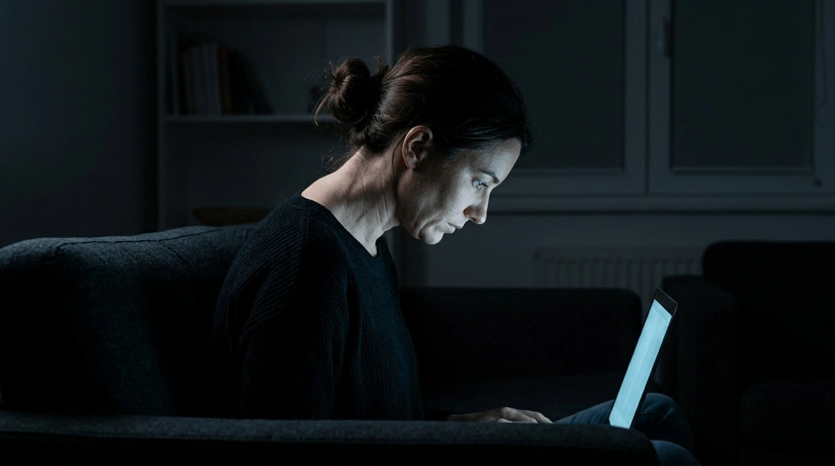 Side profile of a woman looking down at a screen, highlighting tech neck posture.